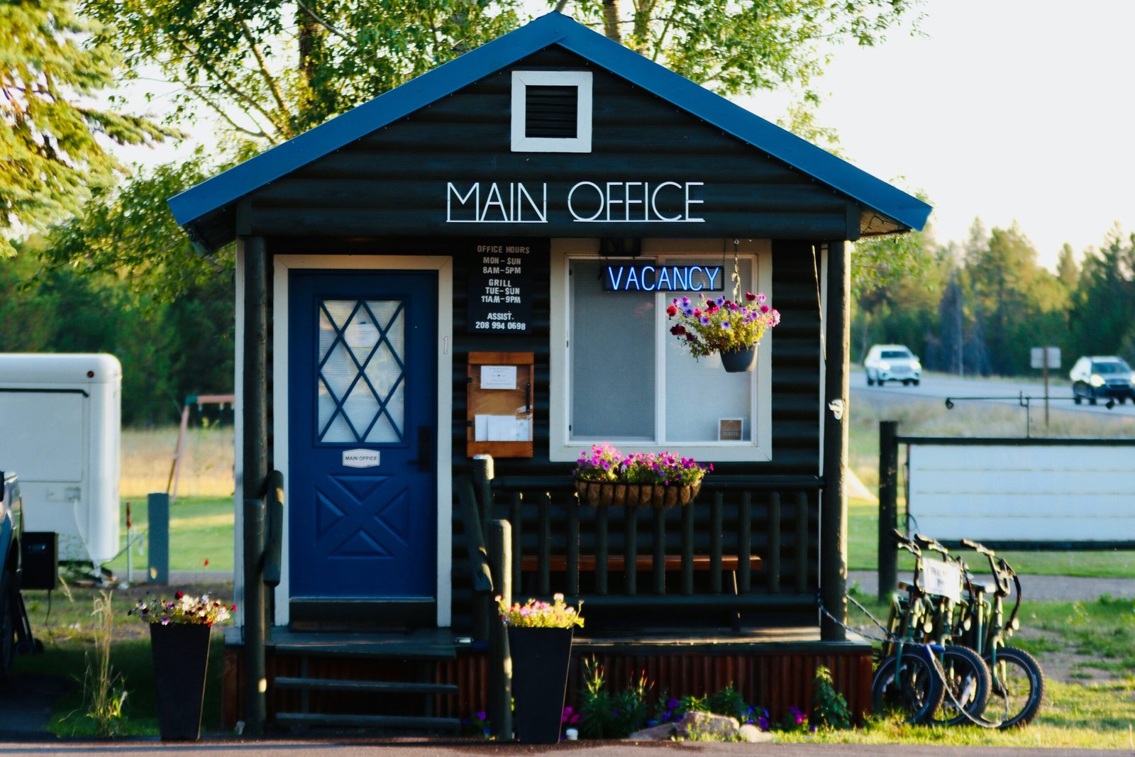 A small black building with a blue door